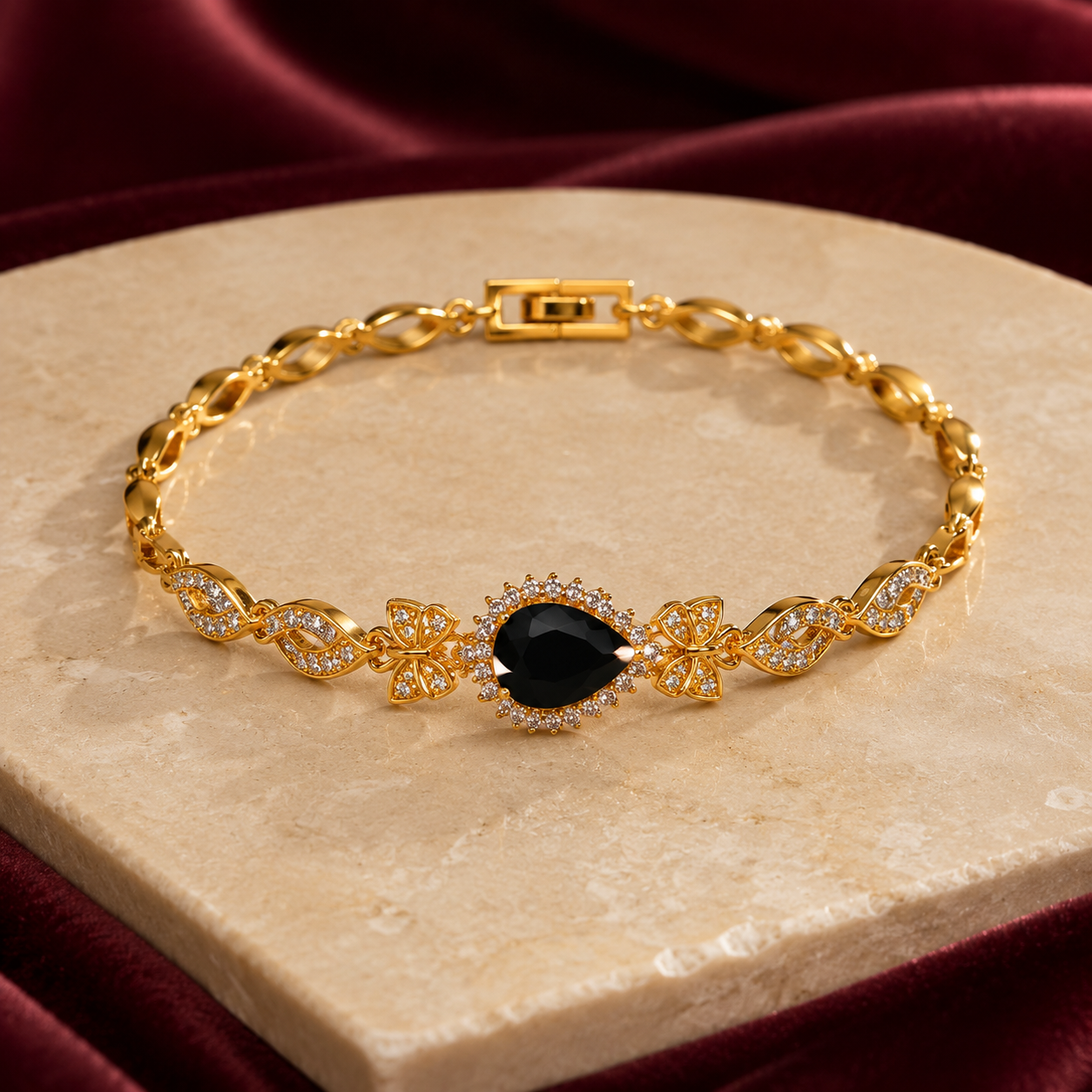 Noiré gold butterfly bracelet with black pear-cut centre stone
