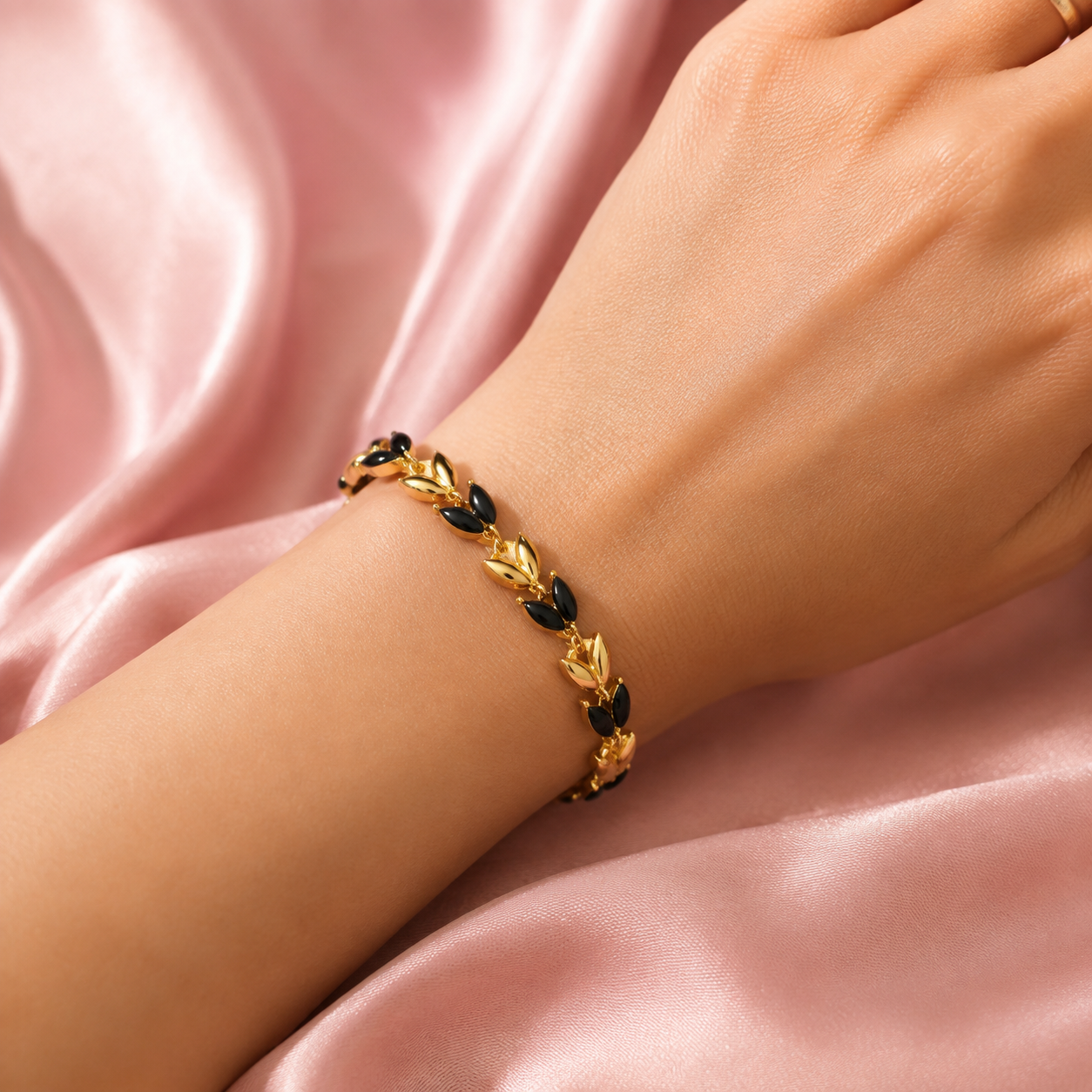 Sylvara gold bracelet with black marquise leaf stones