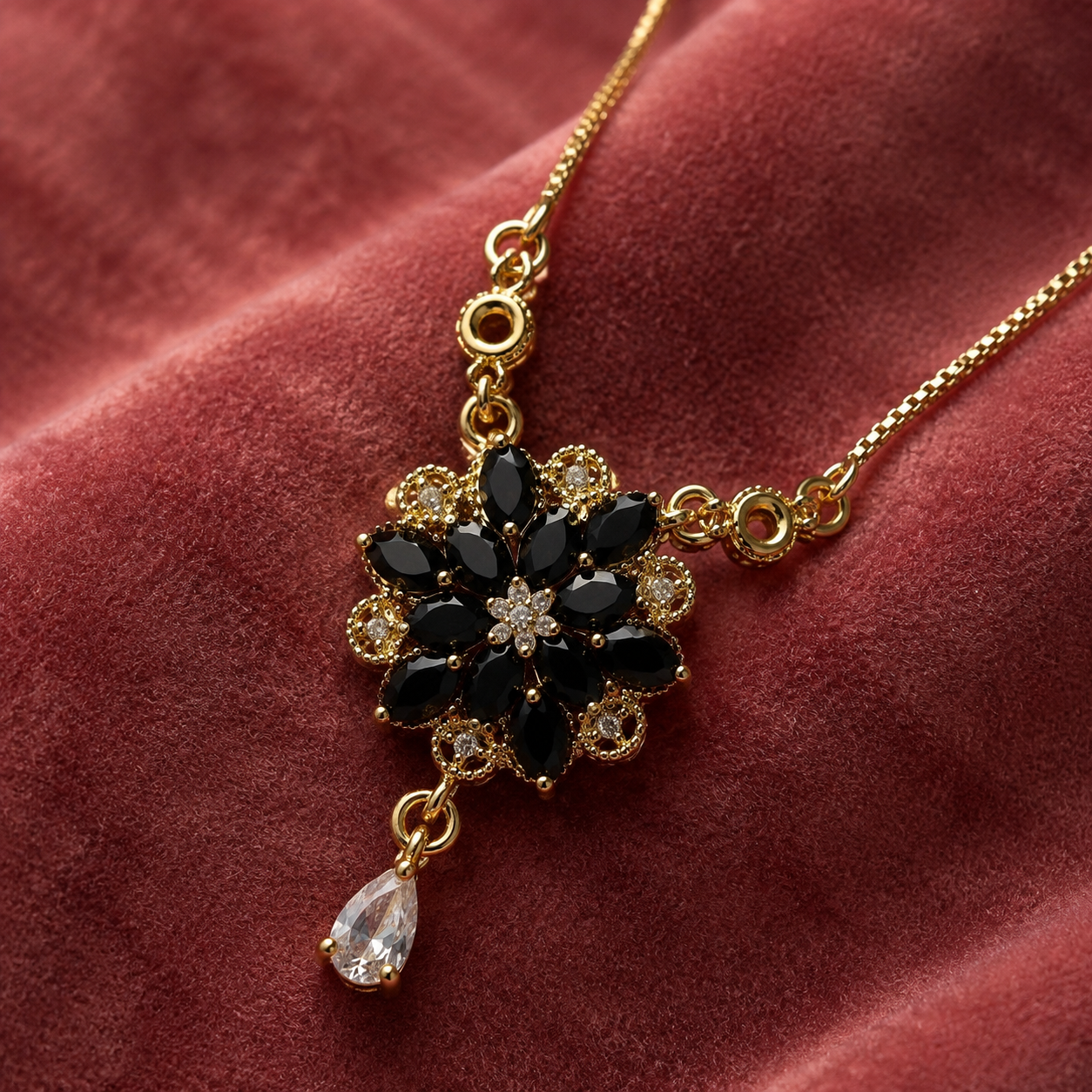Close-up of black floral pendant and teardrop stone