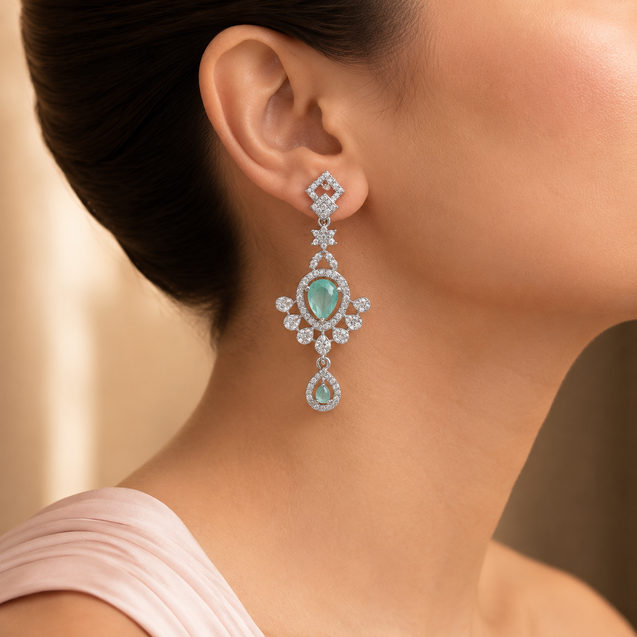 Angled view of aqua teardrop statement earrings
